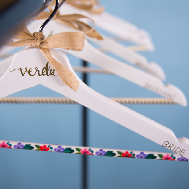 white personalized hangers with gold writing