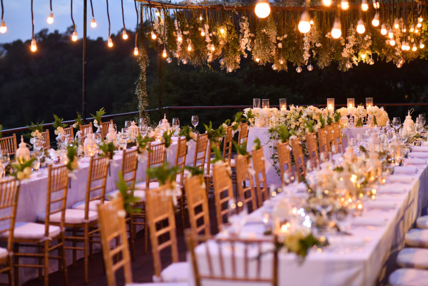 dimly lit wedding venue with greenery and string lights