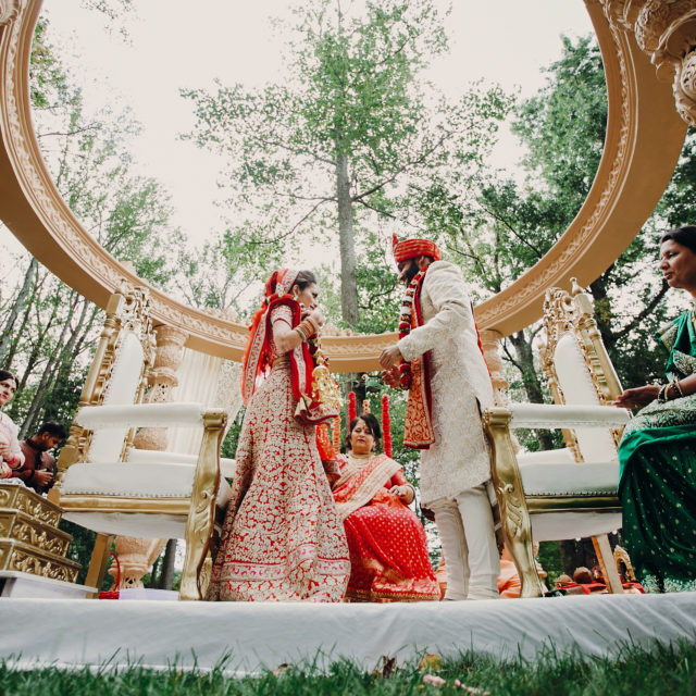 Hindu bride and groom complete wedding rituals outside